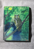 mini art magnet owl in tree on river